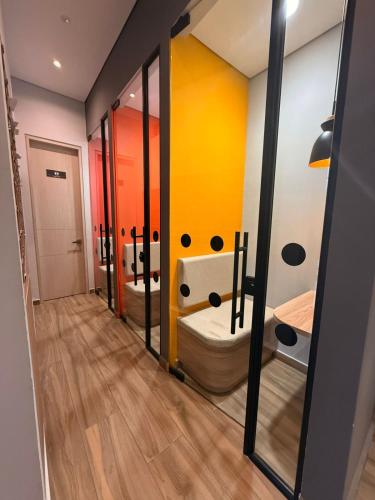 a bathroom with three sinks and a toilet at Apartasuite Cowork in Bogotá