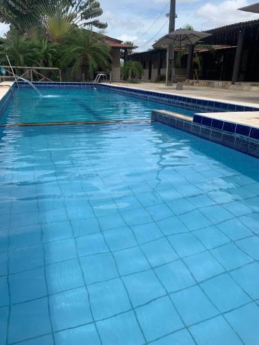 a large swimming pool with blue tiles on it at Sitio Resenha in Caucaia