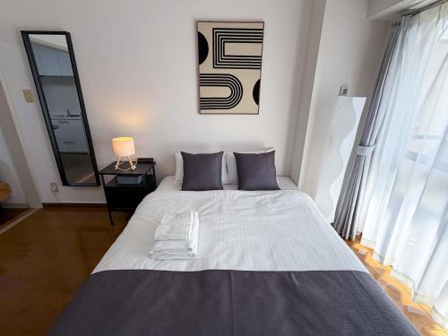 a bedroom with a large bed in a room at OUCHI HOTEL Peace Memorial Park in Hiroshima