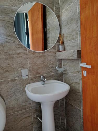 a bathroom with a sink and a mirror at Alojamiento RuOli in Valle Hermoso