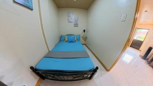 a bed in a room with a mirror at CLBC Residences 1A in Ibaba