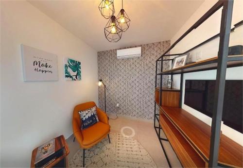 a living room with a bunk bed and a chair at Casa Tronos in San Isidro de los López