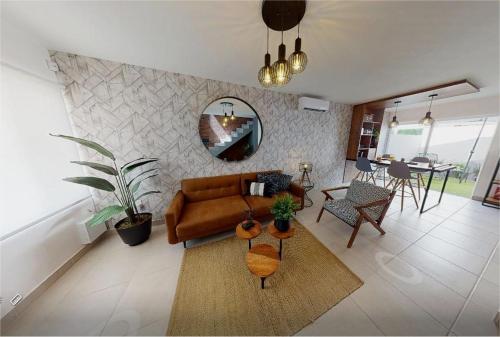 a living room with a brown couch and a table at Casa Tronos in San Isidro de los López