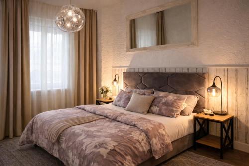 a bedroom with a large bed and a large window at Pension Zur Alten Post in Havelberg