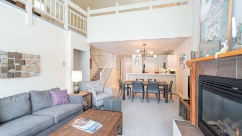 a living room with a couch and a tv and a table at Etta Place Too 113 by AvantStay Close to Town The Slopes In Complex w Communal Pool Hot Tub in Telluride