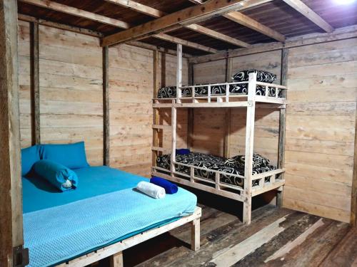a room with bunk beds in a cabin at Baho Farm Stay in Gunungsitoli