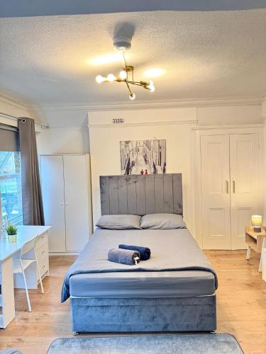 a bedroom with a large bed with a blue mattress at The Prestige Suite - London in London