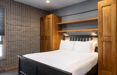 a bedroom with a large bed with white sheets at Vail 21 - CoralTree Residence Collection in Vail