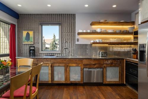 a kitchen with a counter and a table with chairs at Vail 21 - CoralTree Residence Collection in Vail