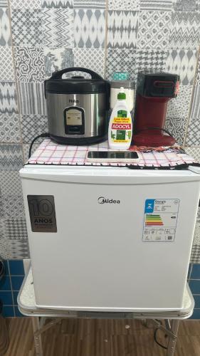 a appliance sitting on top of a refrigerator at Na Ladeira Studio 06 in Rio de Janeiro