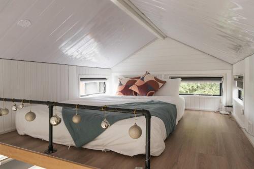a bedroom with a bed in the middle of a room at Sweet Hart 1 by Tiny Away in Tamahere