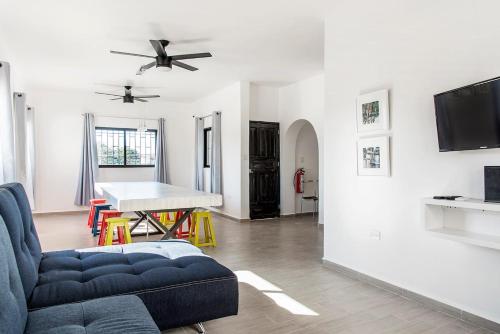 a living room with a blue couch and a table at Valentina Suites by Las Flores Vacation Rentals in Playa del Carmen