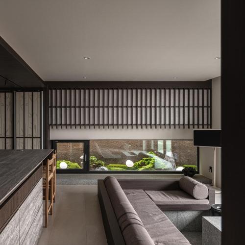 a living room with a couch and a large window at Goyuhanga in Busan