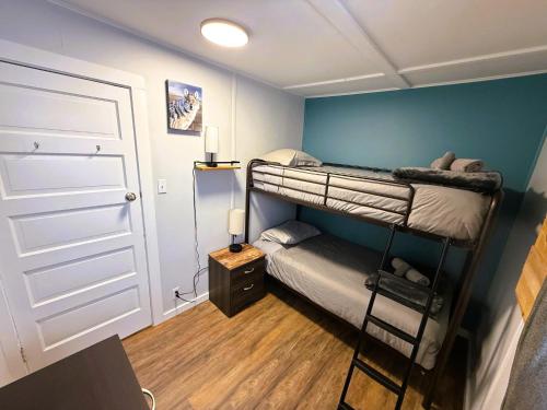 a room with two bunk beds and a door at Beluga Beach House in Churchill