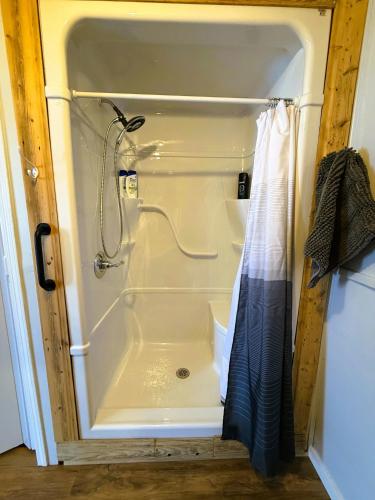 a white shower in a bathroom with a shower at Beluga Beach House in Churchill