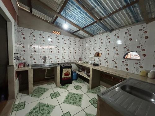 a kitchen with a sink and a tile floor at Quarto Boto Tucuxi in Santarém