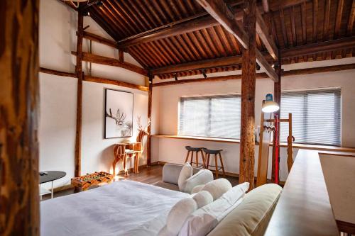 a room with a bed and a couch in it at Sanfuyizhai Homestay in Taizhou