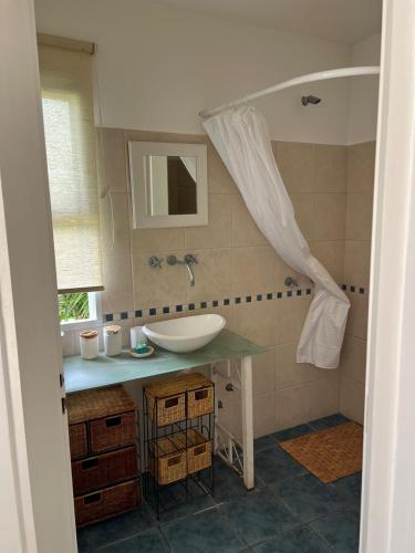 a bathroom with a sink and a mirror at Casa Azul in San Pedro