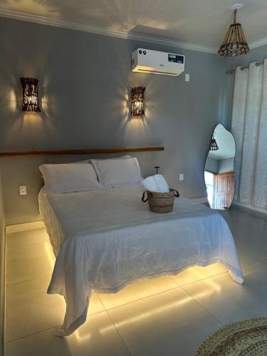 a bedroom with a bed with a basket on it at Hotel Pousada Vila da Natureza in Maceió