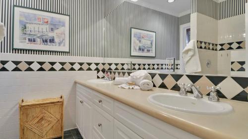 a bathroom with a sink and a mirror at Amelia Home by AvantStay In Historic Old Town w Pool in Key West