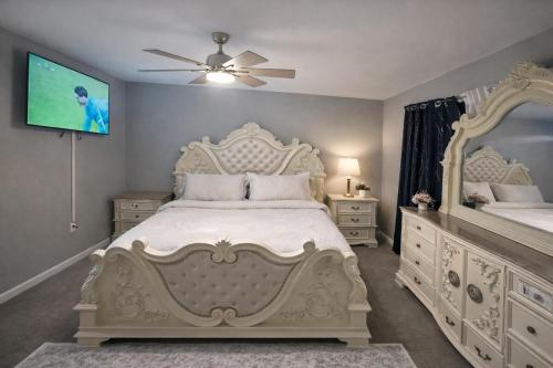 a bedroom with a white bed with a ceiling fan at Spacious 3 bedroom duplex home inside Worcester in Worcester