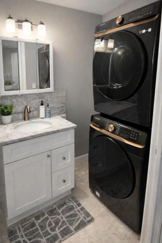 a bathroom with a black microwave and a sink at Spacious 3 bedroom duplex home inside Worcester in Worcester