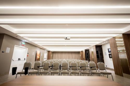 a conference room with a long table and chairs at Fuori le Mura in Altamura