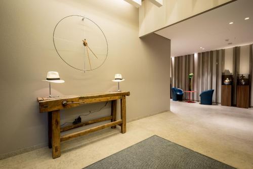 a room with a table and a clock on the wall at Fuori le Mura in Altamura