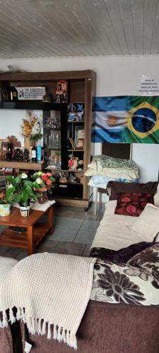 a room with two beds and a table with plants at Pousada Maria Guapa 2 in São Gabriel