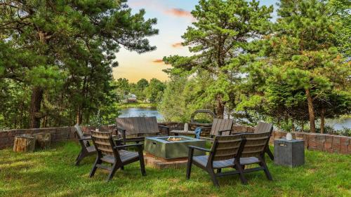 a group of chairs sitting around a table in the grass at For Lake Sake by AvantStay Lakefront Hot Tub View in Long Pond
