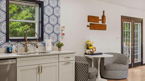 a kitchen with a sink and a chair and a window at For Lake Sake by AvantStay Lakefront Hot Tub View in Long Pond