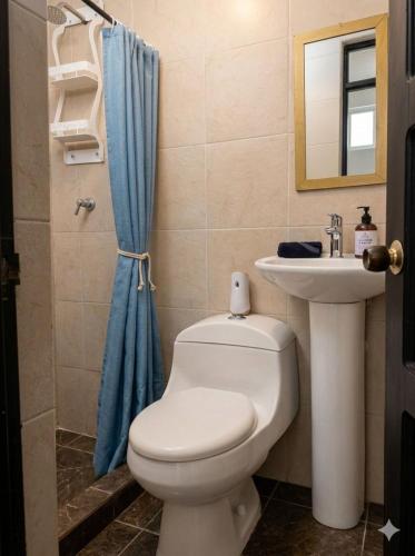 a bathroom with a toilet and a sink at Tu Espacio en Ibague in Ibagué