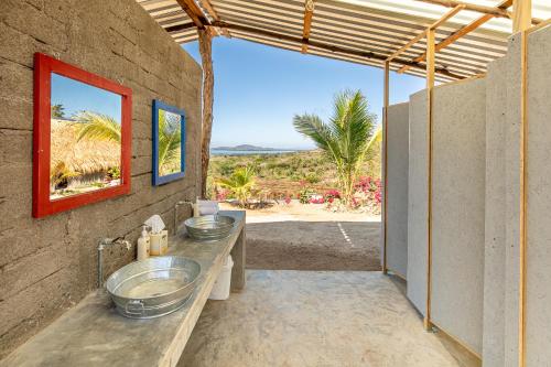 a bathroom with two sinks and a view of the desert at The Dream Eco Glamping in La Sabrosa