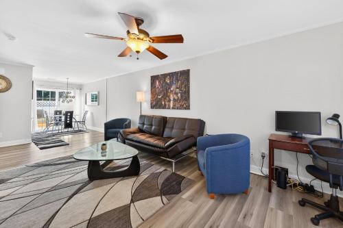 a living room with a couch and a ceiling fan at Executive & Luxury 2-bedroom Townhouse with Pool in Greensboro