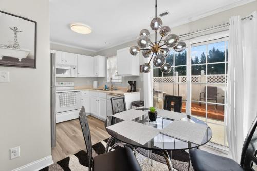 a kitchen and dining room with a table and chairs at Executive & Luxury 2-bedroom Townhouse with Pool in Greensboro