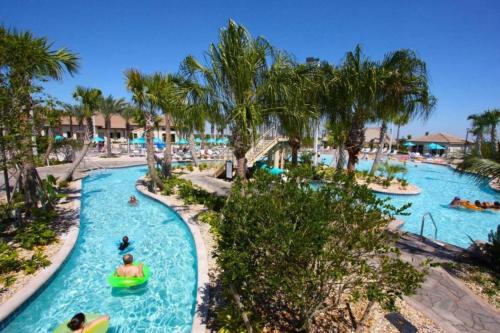a group of people in a pool at a resort at Resort Style, close to Disney and other parks in Davenport
