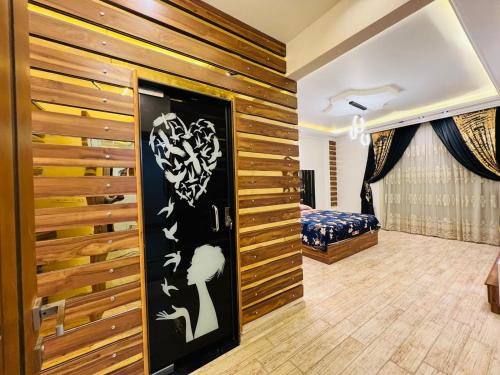 a room with a bed and a wooden wall at Dreams Garden VIP Villa in Sphinx International Airport