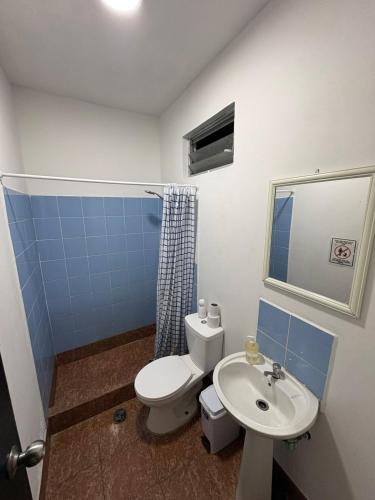 a bathroom with a toilet and a sink at Raymi House Hostel in Arica