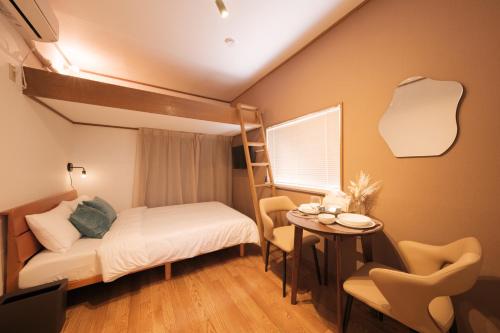 a bedroom with a bunk bed and a table at 茜 Akane in Kawasaki