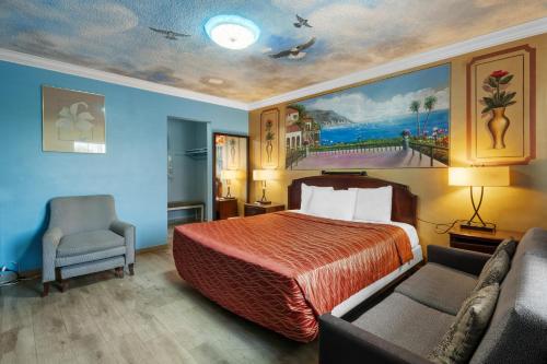a hotel room with a bed and a couch at Villa Park Motel in Orange