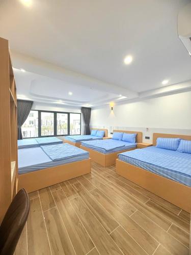 a large room with four beds in it at Phương Ngân HOTEL in Hà Tiên