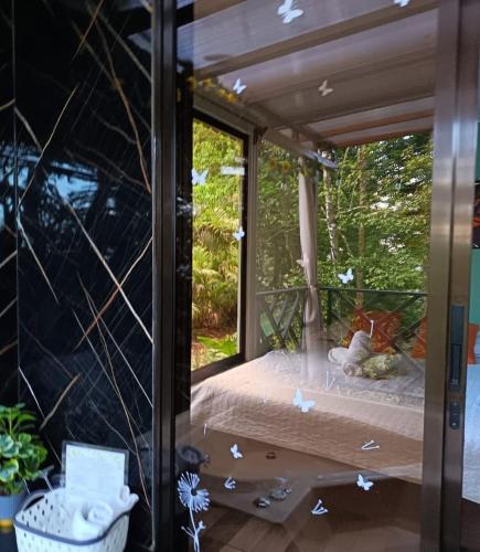 a room with a window with origamiami butterflies on it at Breezes Ecolodge in San Ramón