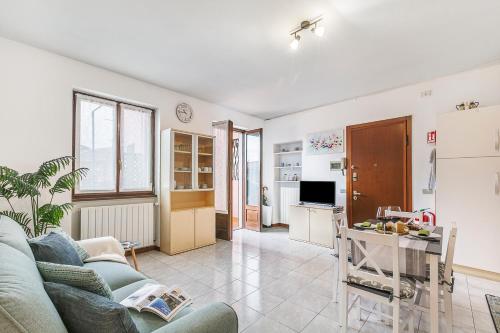 a living room with a couch and a table at Petalo Bianco: 100m from Lake, Parking and Balcony - Happy Rentals in Baveno