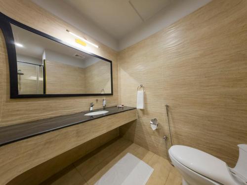 a bathroom with a sink and a mirror at Hotel One Gujranwala in Kot Mergulla