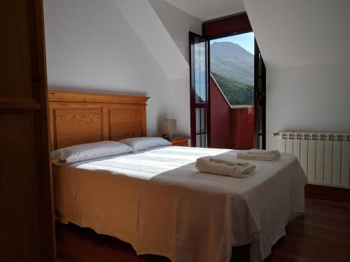 a bedroom with a bed with two towels on it at Hidden Gem in Ramales de la Victoria in Ramales de la Victoria