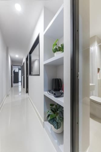 a hallway of a house with white walls and shelves at Petchaburi31 Platinum Suite Home in Bangkok