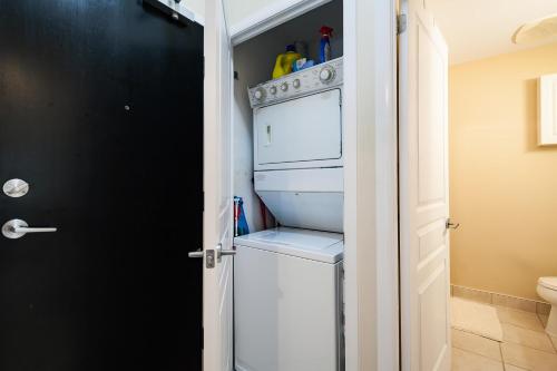 a white washer and dryer in a bathroom at The Yonge Suites in Toronto