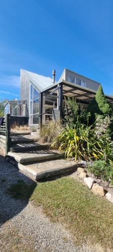 a house with a pathway in front of it at Waypoint Lodge in Naseby