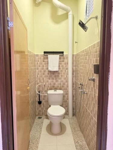 a bathroom with a toilet and a shower at Summer village in Kampong Pasir Hantu