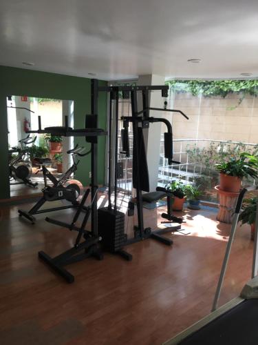 a gym with several treadmills and exercise bikes at Grupo Kings Suites - Bosques de Duraznos 78 in Mexico City